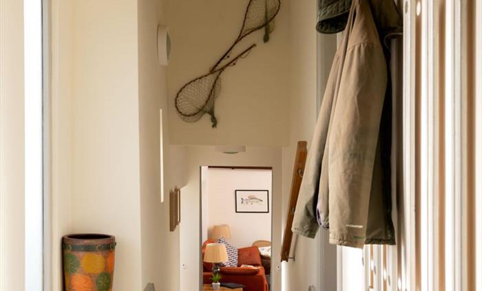 The entrance hallway with two sets of steps down into the living space